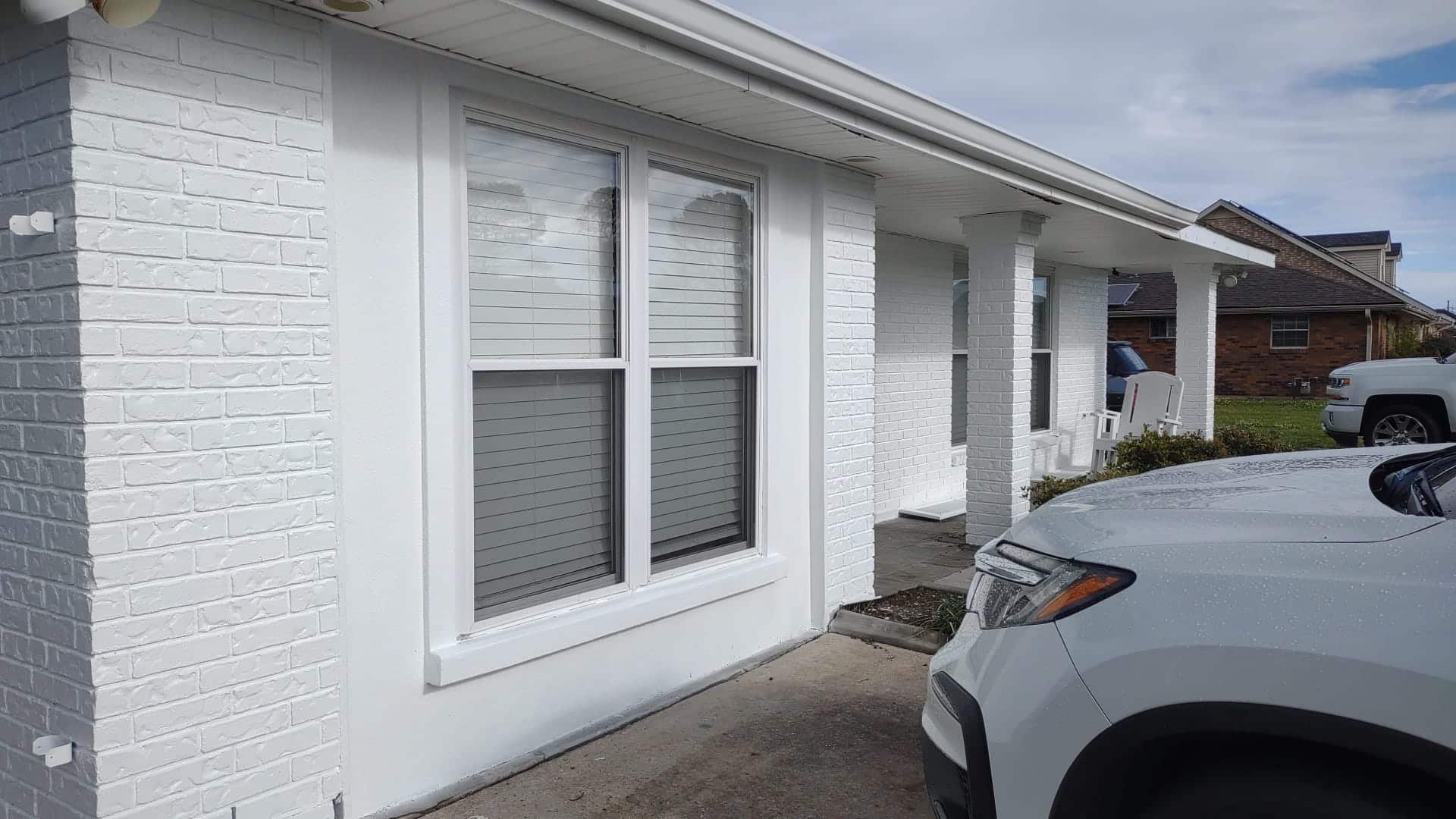 A repainted house exterior in white with fresh trim
