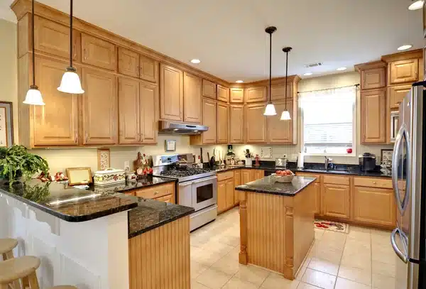 A kitchen with maple cabinet doors and painted walls above the worktop