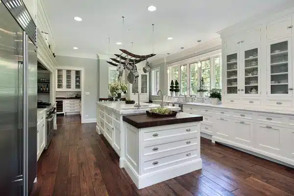A white painted kitchen with an island and fitted cabinet doors