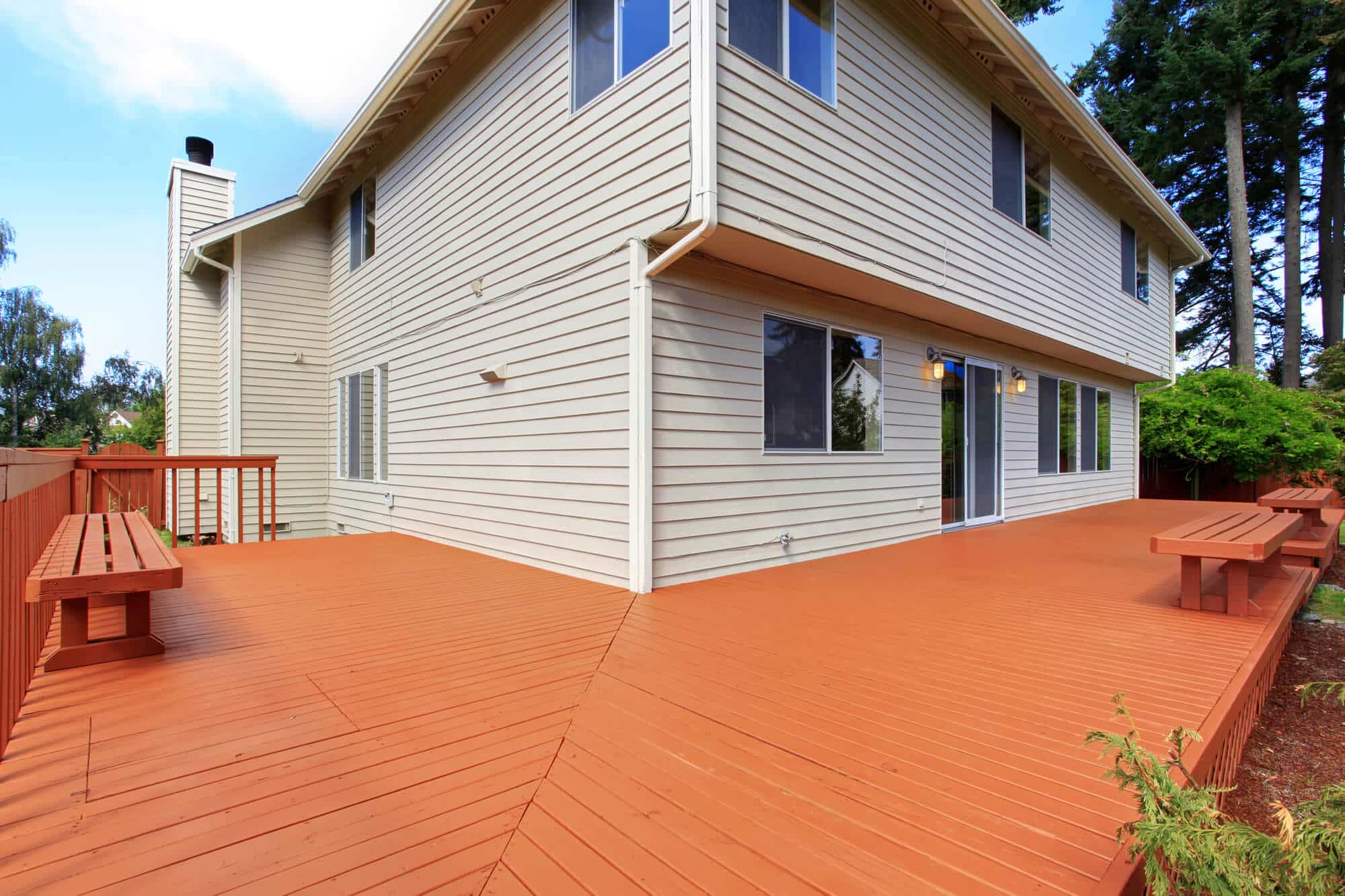 A wood deck finished in a warm brown coating