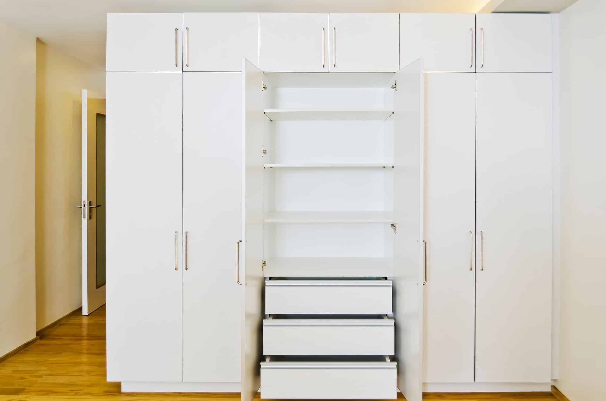 Fitted cabinets in a repainted room with contrasting walls