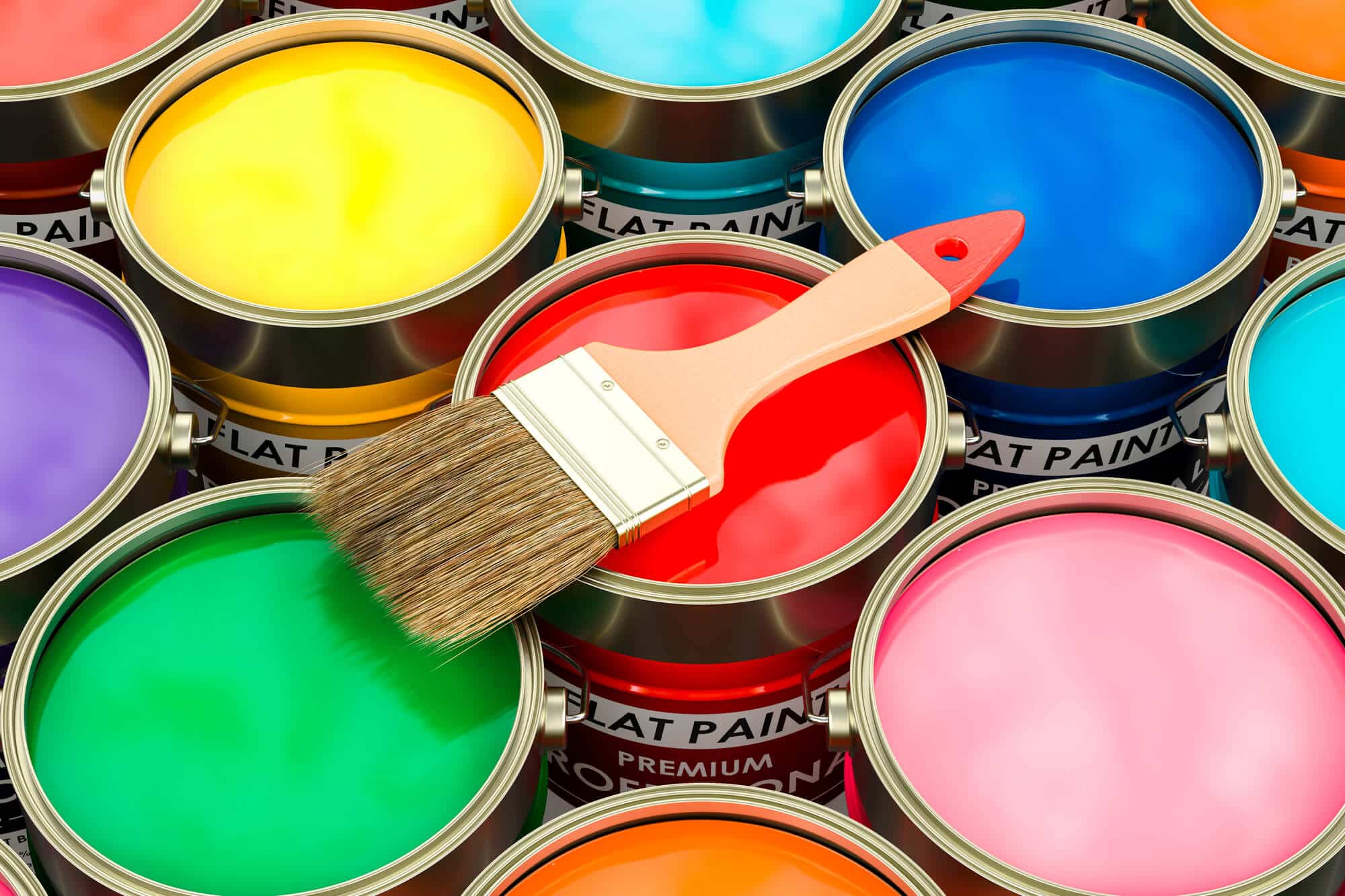 Open cans of paint in many colors seen from above with a brush resting across them