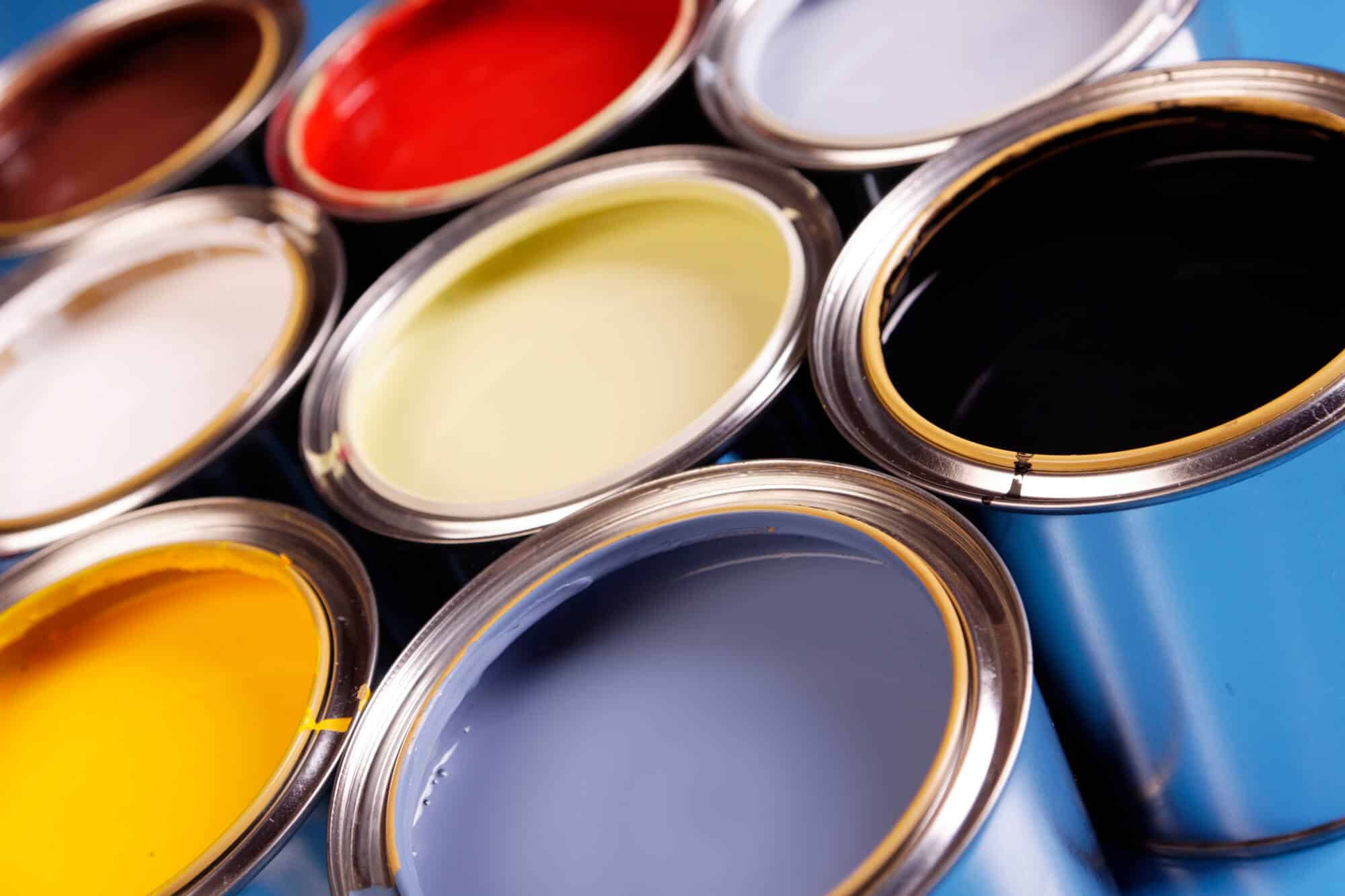 Open cans of paint in mixed colors seen from above