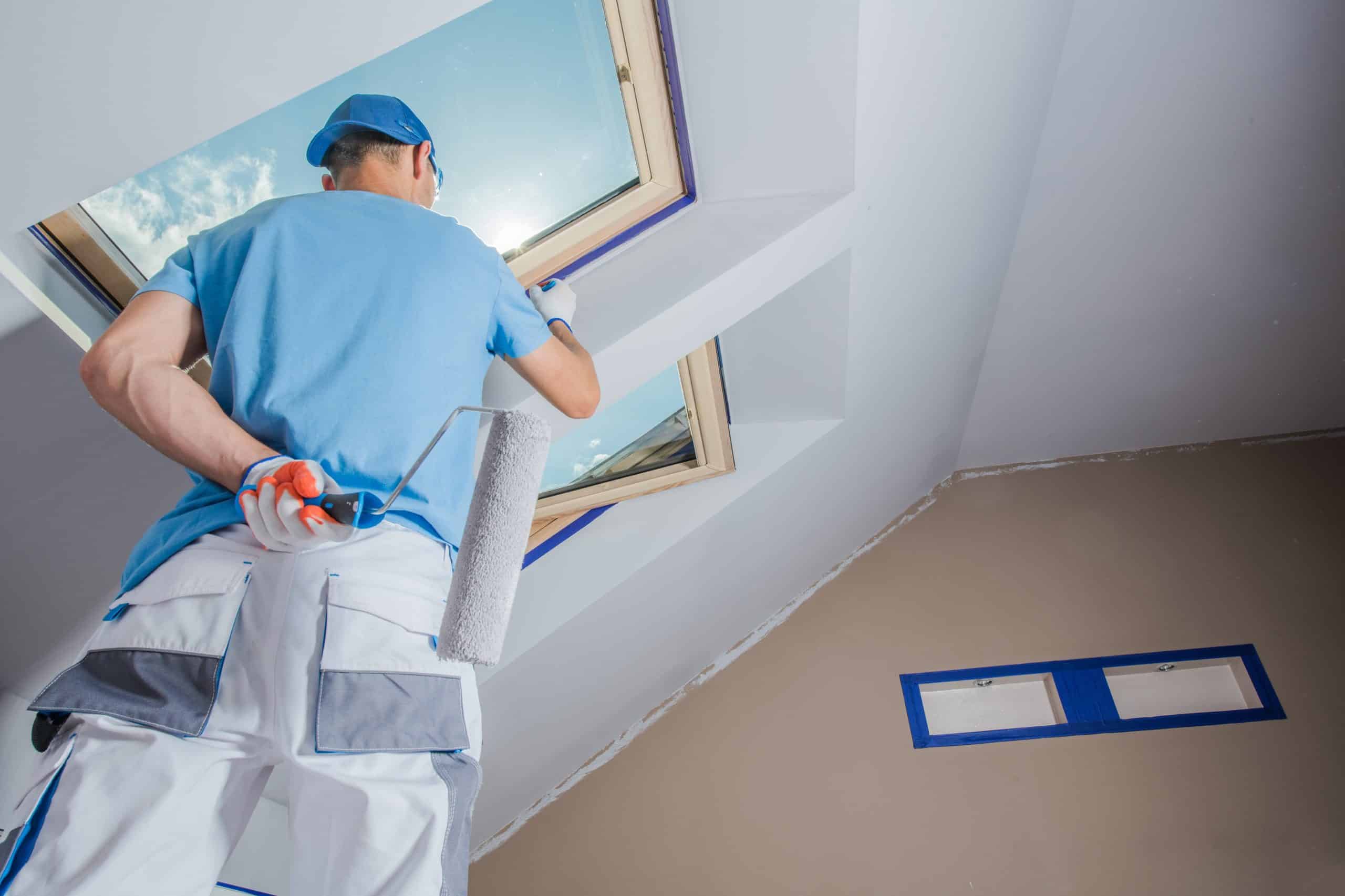 A painter working on the walls of an empty apartment