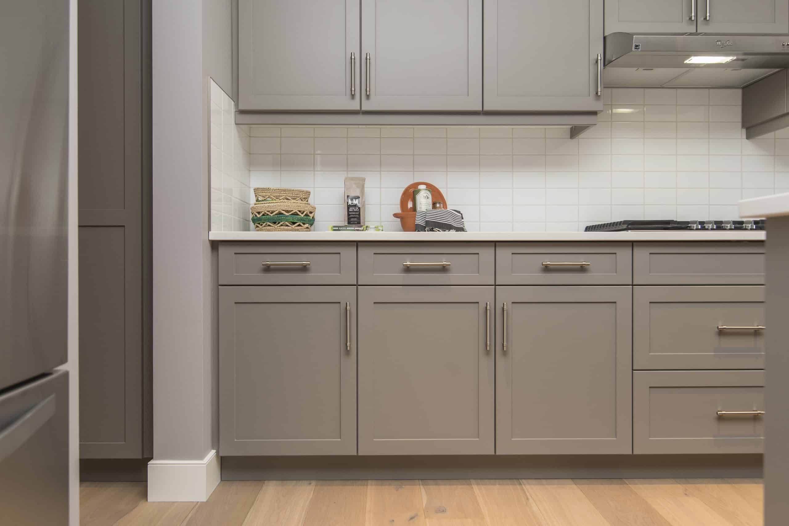 A modern kitchen with pale cabinets after repainting