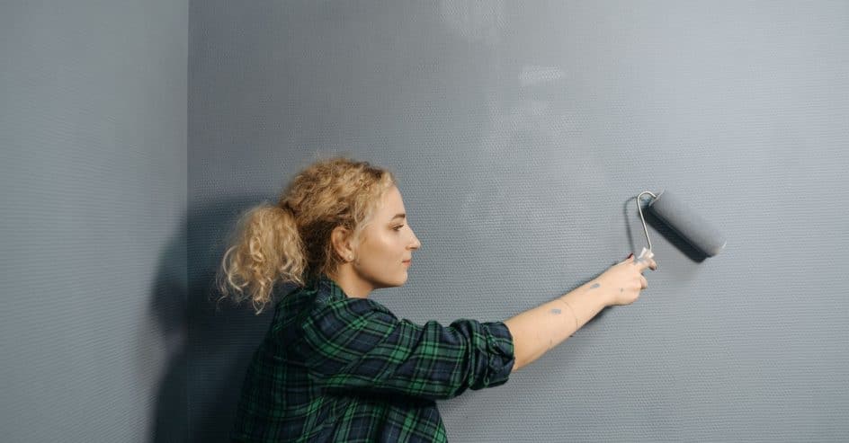 Painter rolling fresh paint on a commercial interior wall