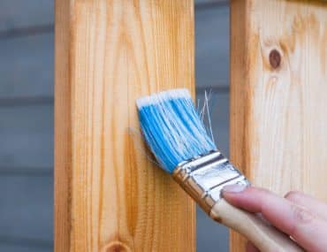 Applying stain to wooden boards with a brush