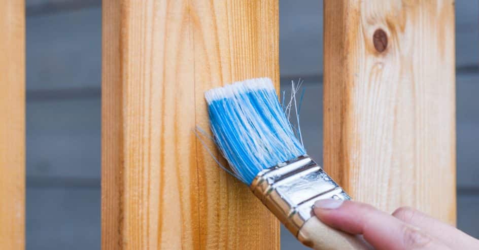 Applying stain to wooden boards with a brush