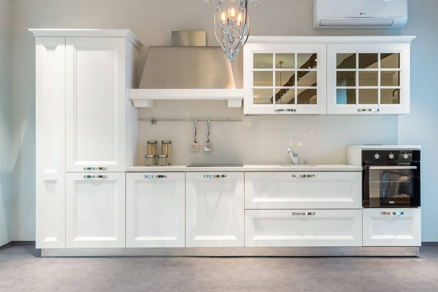 White painted wall cabinets above a run of worktop