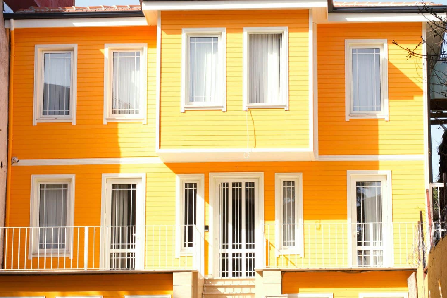 Painted row houses in orange and cream with white trim
