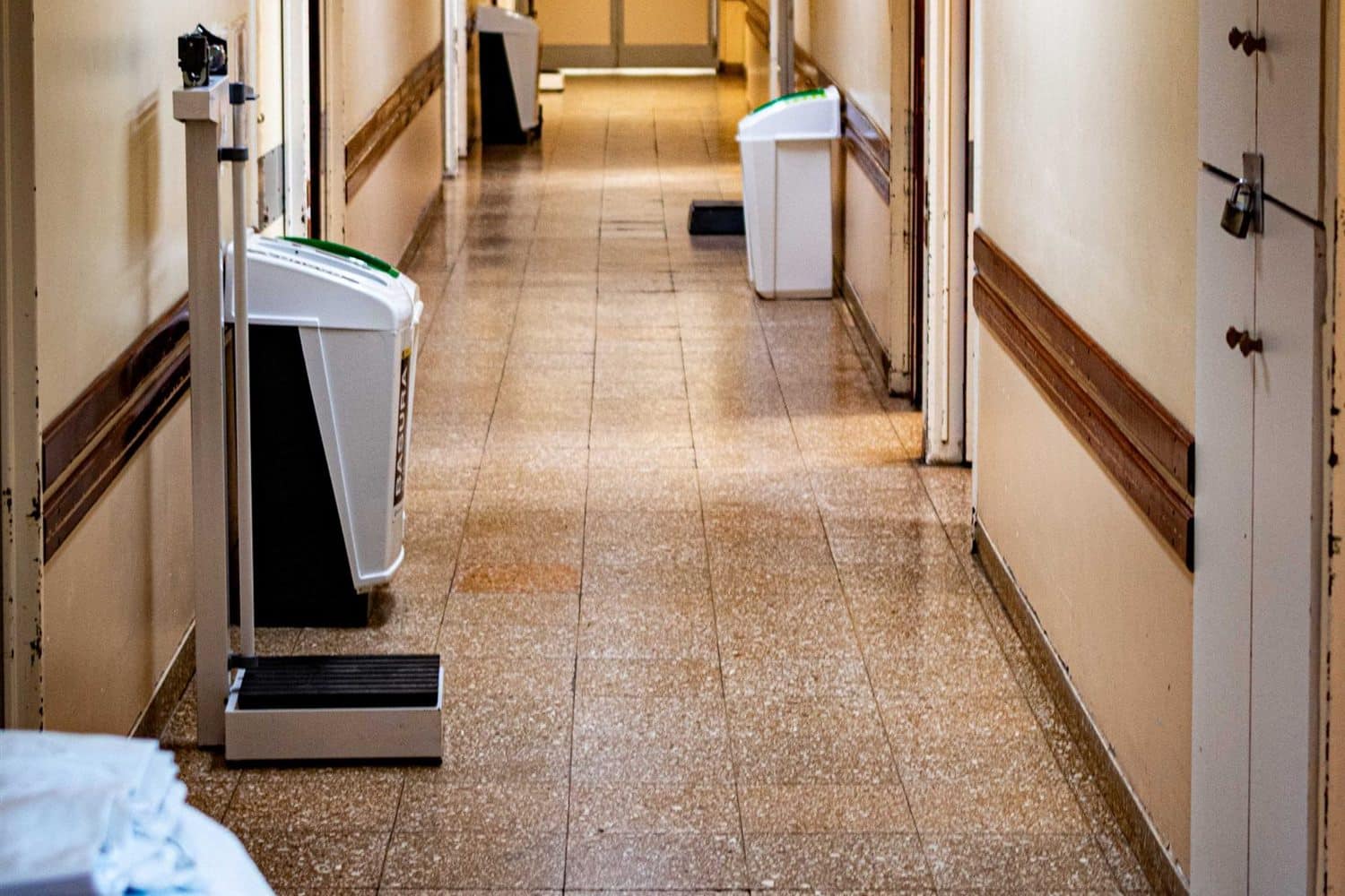 A hospital corridor with equipment along one side