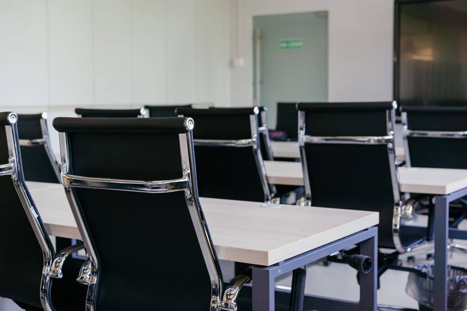 A meeting room with chairs set around a long table
