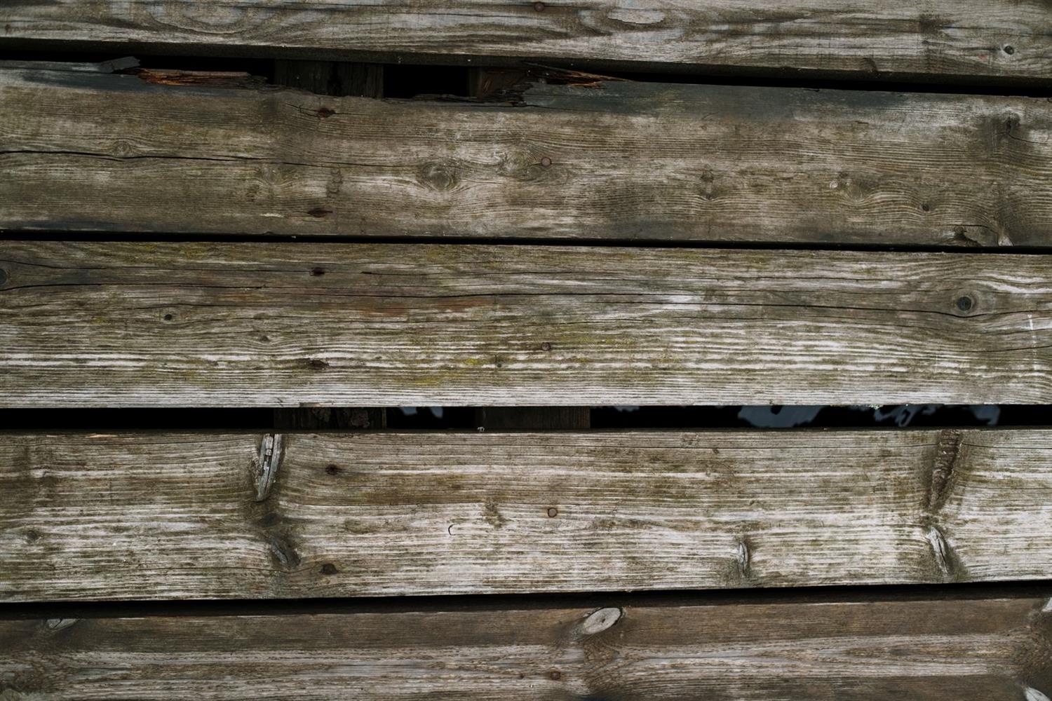 Weathered timber boards before they are washed and coated