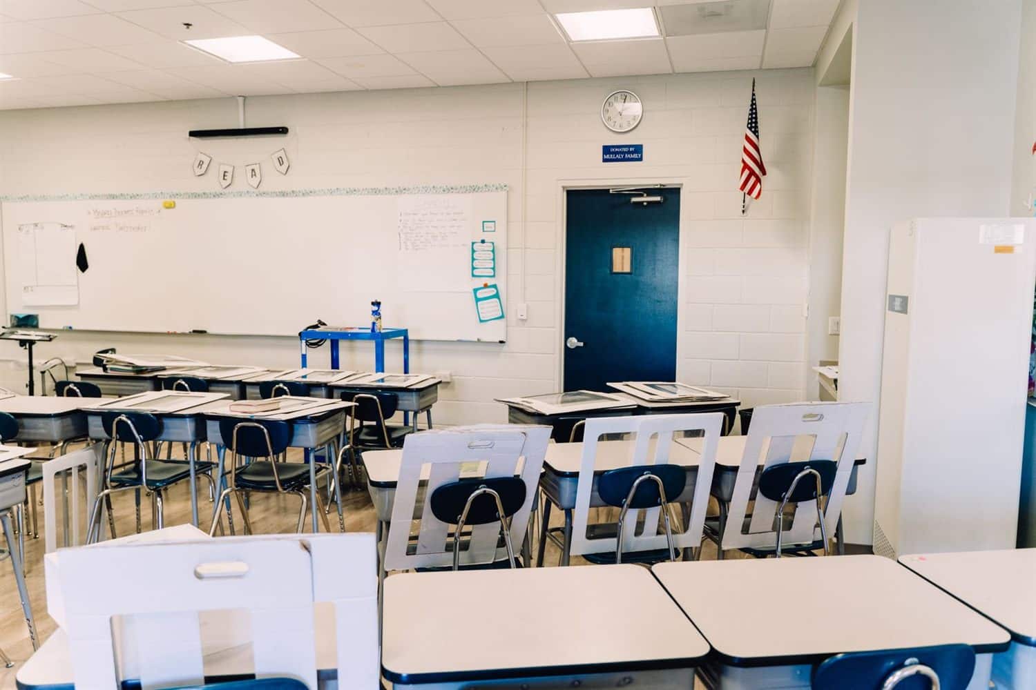 A classroom with grouped tables and a whiteboard