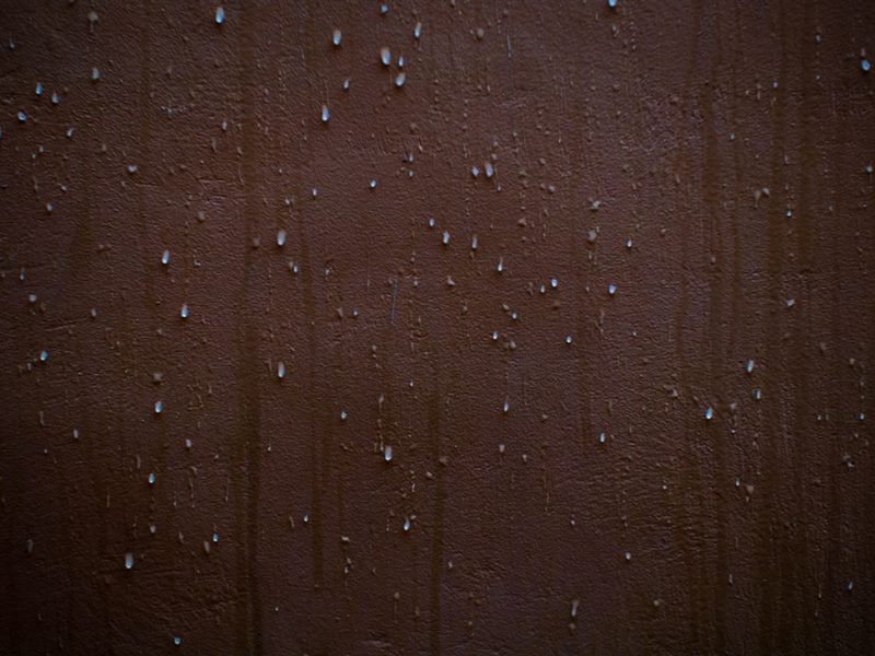 Water beading on a masonry wall after washing